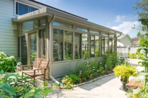 Glass 3 Season Model 300 Sunroom featuring a patio and a lush garden outside.