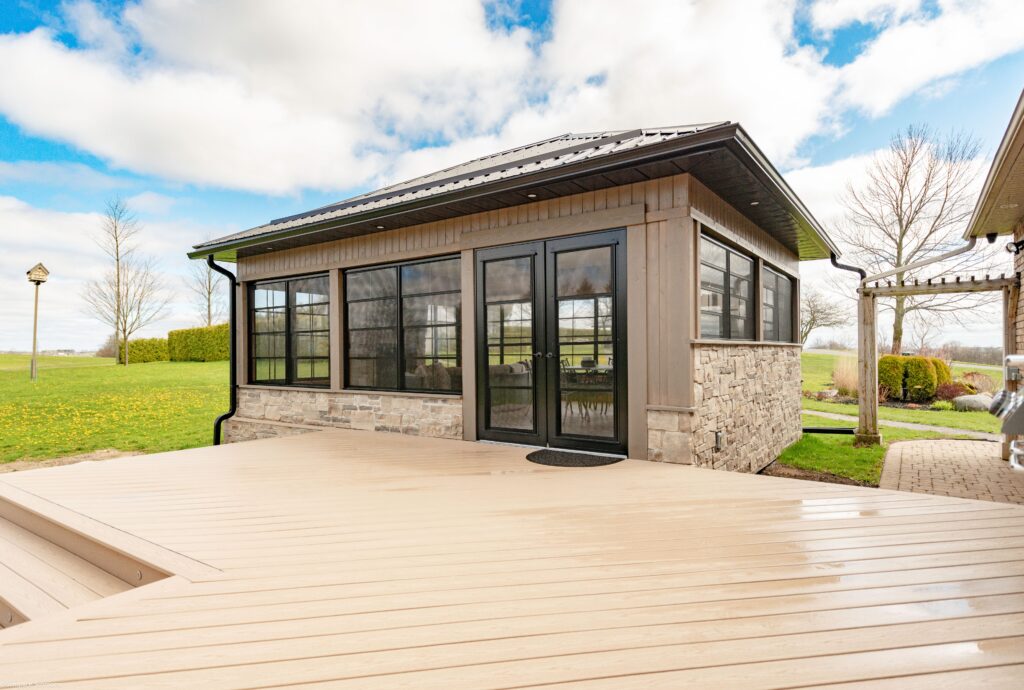 Small house featuring a deck and patio, showcasing WeatherMaster™ Windows & Doors.