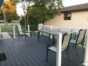 Aluminum Decking featuring a table and chairs arranged on a spacious outdoor deck.