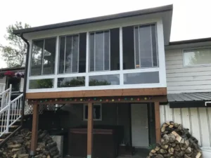 House featuring a deck and fire pit, showcasing the Glass 3 Season Model 300 design.
