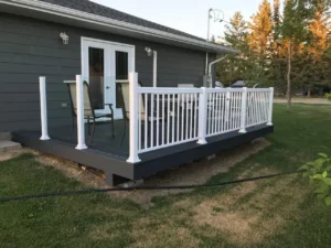 Aluminum Decking a deck with a white railing and a patio area for outdoor living.