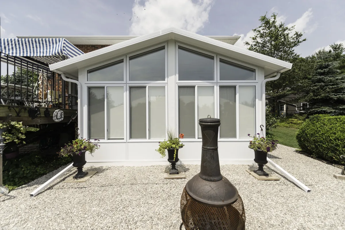 Charming home with patio and fire pit, showcasing Sunshades & Sunlight products.