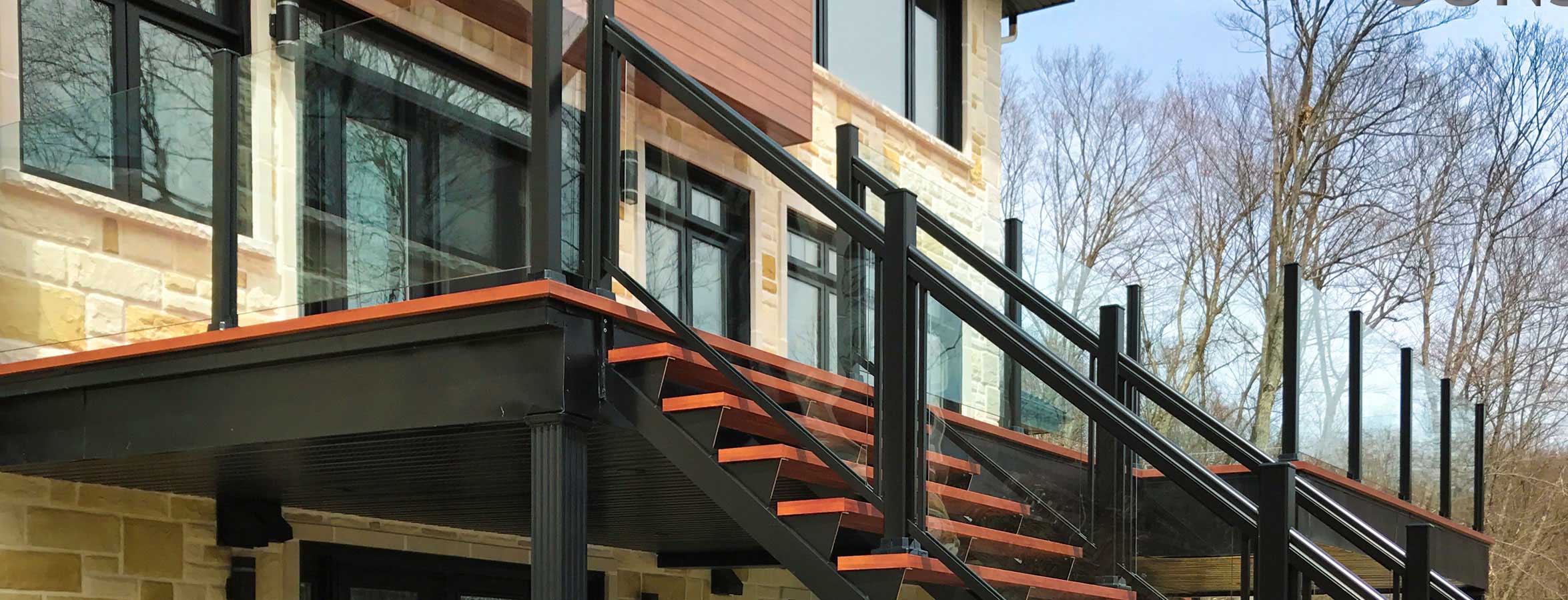 Black and red Aluminum Railing with Glass, featuring stairs leading up to a house entrance.