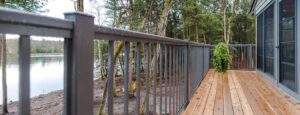 Aluminum Picket Railing on a deck, set against a tranquil lake backdrop.