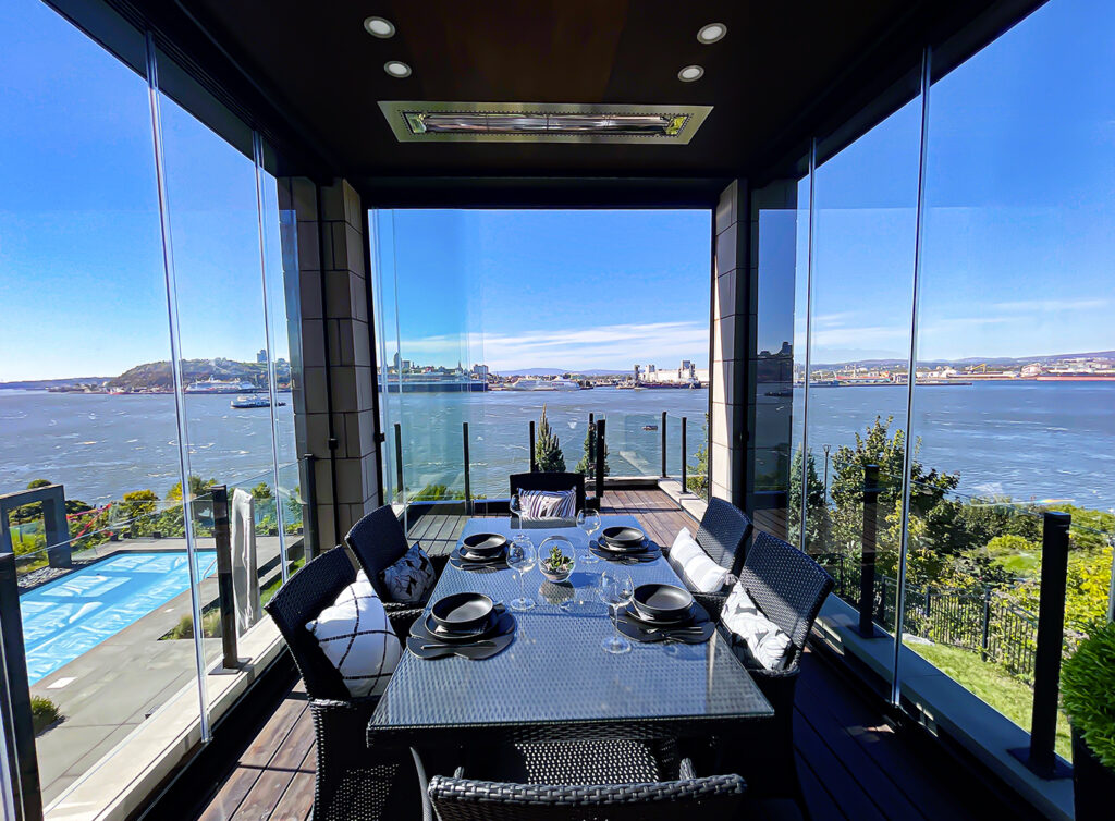 Elegant dinner table arranged in a large glass-enclosed room, featuring Horizon's stylish tableware and decor.