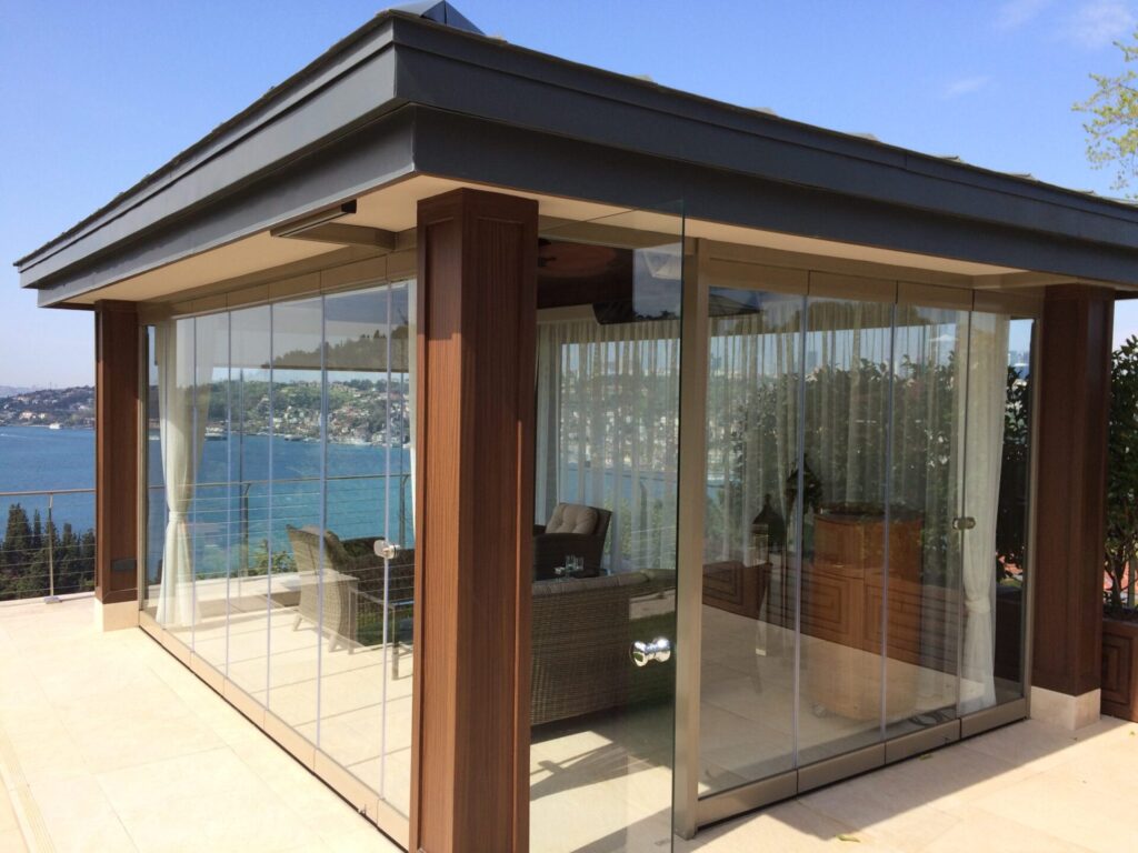 Glass-covered patio with water view Novasun Panoramic Plus