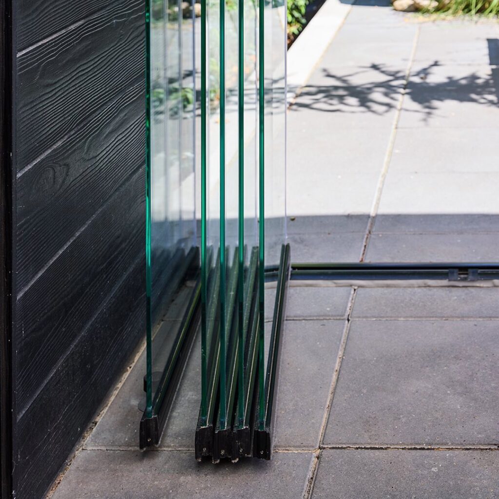 Glass door with black wall, showcasing Novasun Panoramic design