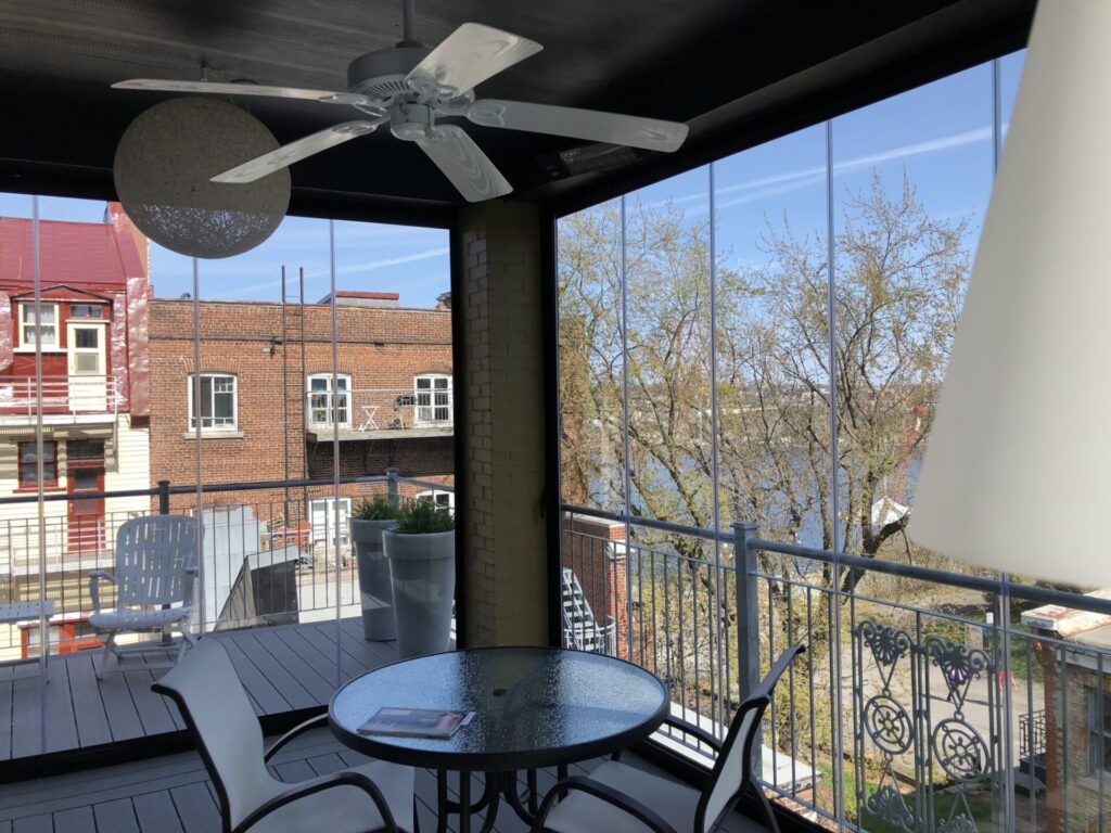 A panoramic view of a balcony featuring a table and chairs, ideal for outdoor relaxation and dining.