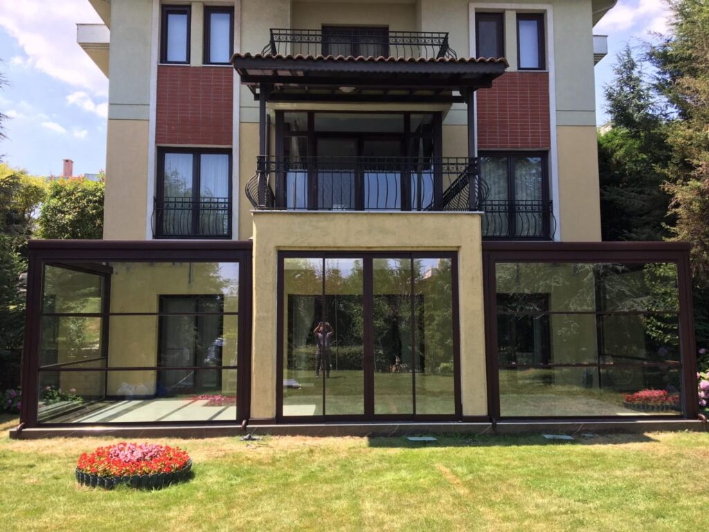 Grand home with a decorative balcony and peaceful backdrop, showcasing its architectural elegance.