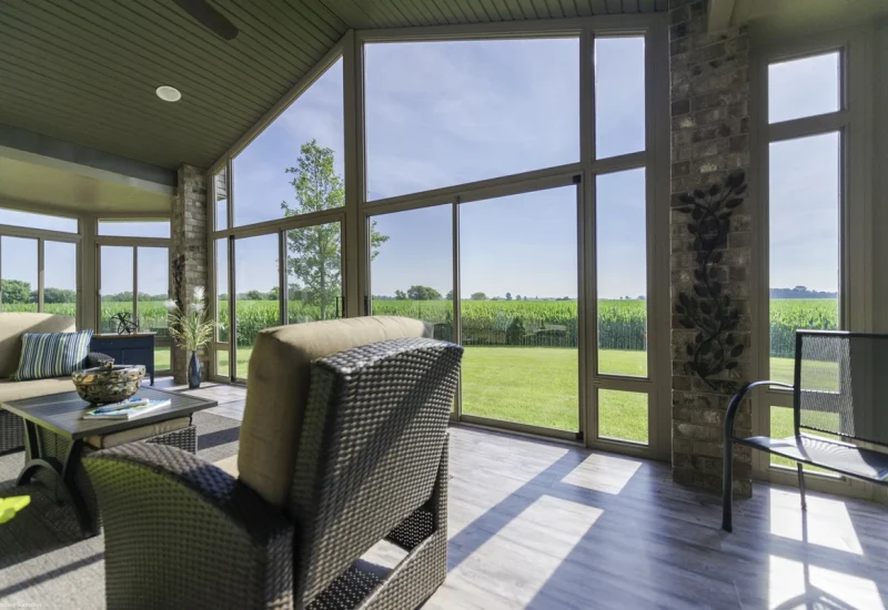 Sunroom with wicker furniture and large windows