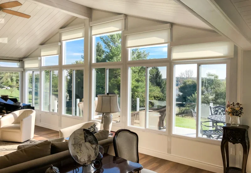 Neutral-toned roller Sunshades installed on patio doors and adjacent windows