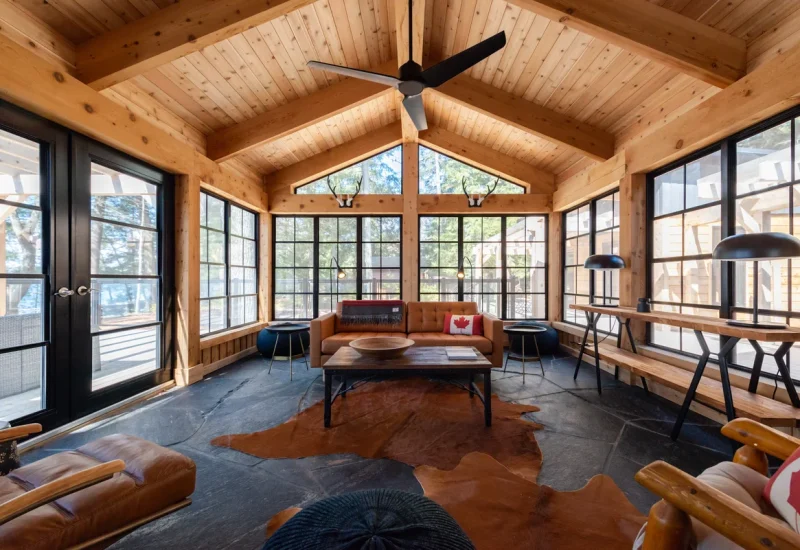 Living room featuring a sofa, armchair, and expansive windows